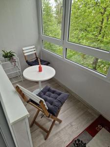 a room with a table and a chair and window at Cozy 3 room appartment in Klaipėda