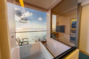 a bath tub with a view of the ocean at Triton Exotica in Maafushi