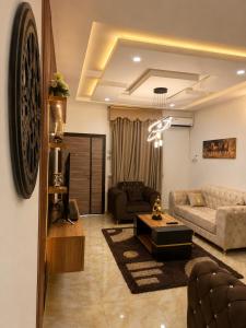 a living room with a couch and a table at Restnest suite in Benin City