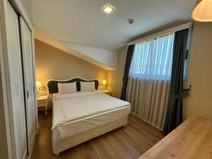 a bedroom with a bed and a large window at Defne Beach Karya in Fethiye +48 photos
