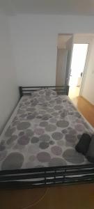 a bedroom with a large bed with a carpet at Ela Gar 1 WG Zimmer Wohngemeinschaft in Garsten