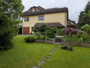 a large house with a garden in front of it at Apartmany u Denyho in Zuberec