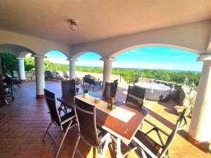 a patio with a table and chairs on a balcony at Dorono House in Balatonudvari
