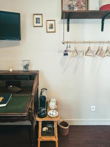a room with a table and a coffee maker on a shelf at Auberge de Chanteuges in Chanteuges