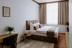 a bedroom with a large bed with a window at Penzion Pod Kašnou in Frýdek-Místek