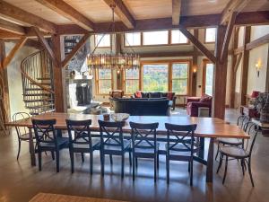 a dining room with a large wooden table and chairs at The Vines in Warren
