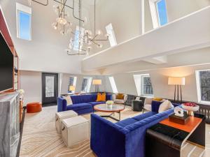 a large living room with blue couches and a chandelier at Fairmont Banff Springs in Banff