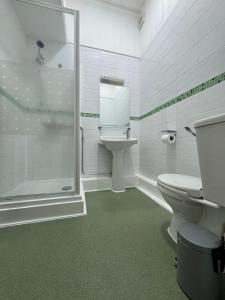 a bathroom with a shower and a toilet and a sink at Trivelles Belforte Hotel , Sale, Manchester - M33 2AE in Sale +105 photos