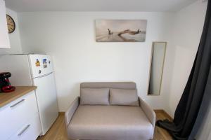 a small room with a chair and a refrigerator at Hulot-838-Iodine parenthesis in Frontignan