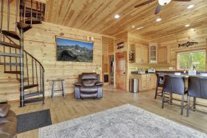 a kitchen and living room with a spiral staircase in a log cabin at Cozy Deer Valley Cabin- Views Fireplace & Deck in Jefferson