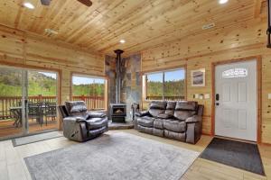 a living room with two leather chairs and a fireplace at Cozy Deer Valley Cabin- Views Fireplace & Deck in Jefferson