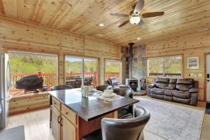 a log cabin kitchen with a ceiling fan and chairs at Cozy Deer Valley Cabin- Views Fireplace & Deck in Jefferson +21 photos