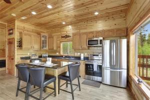 a kitchen with a table and chairs and a refrigerator at Cozy Deer Valley Cabin- Views Fireplace & Deck in Jefferson
