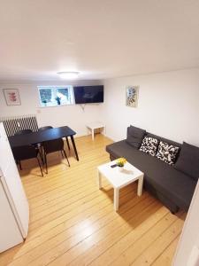 a living room with a couch and a table at Central apartment in Aalborg close to Hospital in Aalborg +10 photos