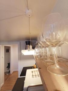 a row of wine glasses sitting on a counter at Central apartment in Aalborg close to Hospital in Aalborg