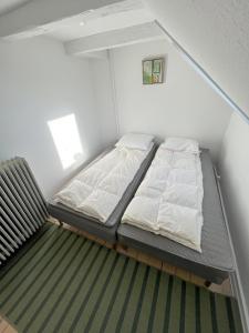a small room with a bed and a couch at Bright and central city apartment near Aalborg Bus in Aalborg