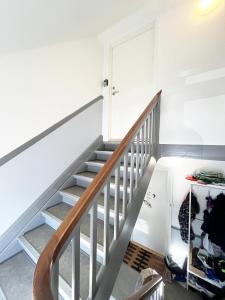 a staircase in a room with a stair case at Bright and central city apartment near Aalborg Bus in Aalborg +7 photos