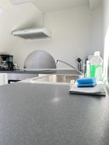 a kitchen with a sink and a counter top at Bright and central city apartment near Aalborg Bus in Aalborg