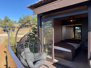 a glass house with a bed and a porch at Minnie Diamond in Divčibare