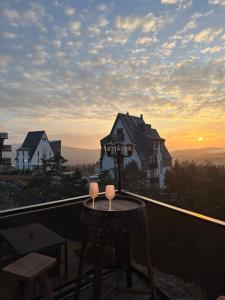 a table with two candles on top of a balcony at Minnie Diamond in Divčibare