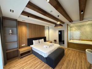 a bedroom with a large bed and a large aquarium at Quba in Quba +14 photos