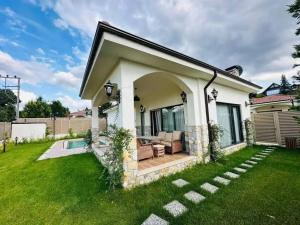 a small white house with a green yard at Quba in Quba