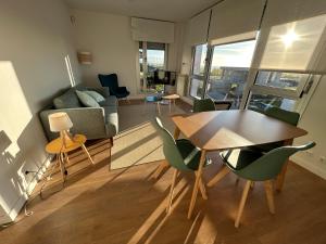 a living room with a table and a couch at TÍA NANDUCA in Liencres