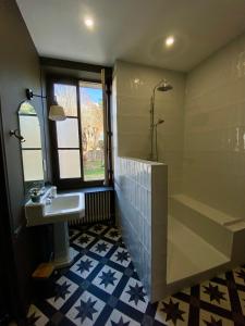 a bathroom with a shower and a sink and a tub at Maison Loire et Mer in Mer