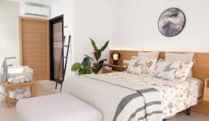 a bedroom with a bed and a clock on the wall at Mariposa in Marbella