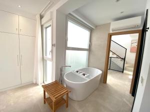 a bathroom with a large white tub and a window at Mariposa in Marbella +17 photos