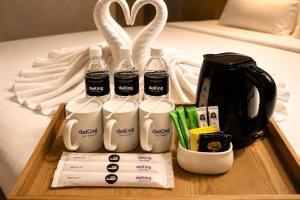 a tray with bottles of milk and a coffee maker at deKing Hotel Twin Towers by DK Hospitality in Kuala Lumpur