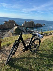 a bike parked on the grass near the ocean at TÍA NANDUCA in Liencres