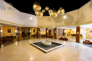 a lobby with a fountain in the middle of a building at Oasis Beach & Spa - Blue Pearl in Saïdia +105 photos