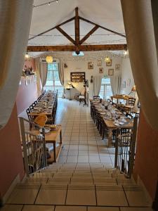 a dining room with tables and chairs in a room at Auberge de Chanteuges in Chanteuges