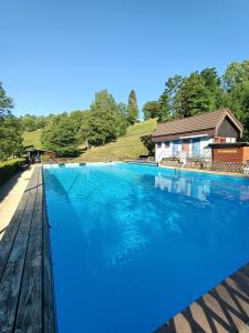 a large blue swimming pool next to a house at Schöne Aussicht in Todtnau