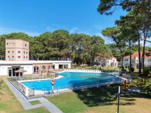 a swimming pool in a yard next to a building at Del Pinar Apart in Costa del Este