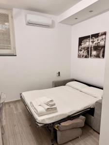 a white room with a bed and a couch at Casa Valentina in Tropea