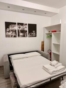 a bed in a room with two pictures on the wall at Casa Valentina in Tropea