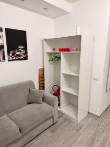 a living room with a couch and a book shelf at Casa Valentina in Tropea +8 photos