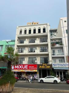 a white car parked in front of a building at Khách Sạn PG Boutique in Vung Tau