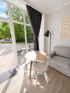 a living room with a table and a couch at Glūdas Grava in Cēsis