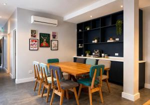 a dining room with a wooden table and chairs at Los Patios de Julia by DOT Boutique in Buenos Aires