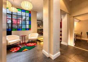 a lobby with chairs and a stained glass window at Los Patios de Julia by DOT Boutique in Buenos Aires