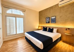 a bedroom with a large bed and a window at Los Patios de Julia by DOT Boutique in Buenos Aires