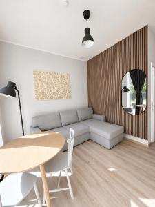 a living room with a couch and a table at Glūdas Grava in Cēsis +9 photos