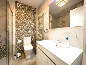 a bathroom with a white sink and a toilet at Increíbles vistas al mar A102 in Torrox Costa +9 photos