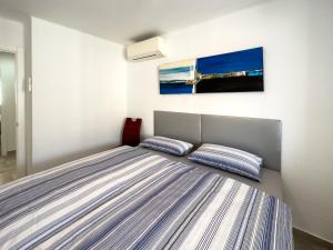 a bedroom with a bed with two pillows on it at Increíbles vistas al mar A102 in Torrox Costa