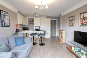 a living room with a couch and a kitchen at Greenfields Apartment in Chester +8 photos