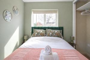 a bedroom with a bed with a towel on it at Greenfields Apartment in Chester