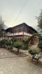 a large building with a staircase in front of it at Parma Guest House in Kasol